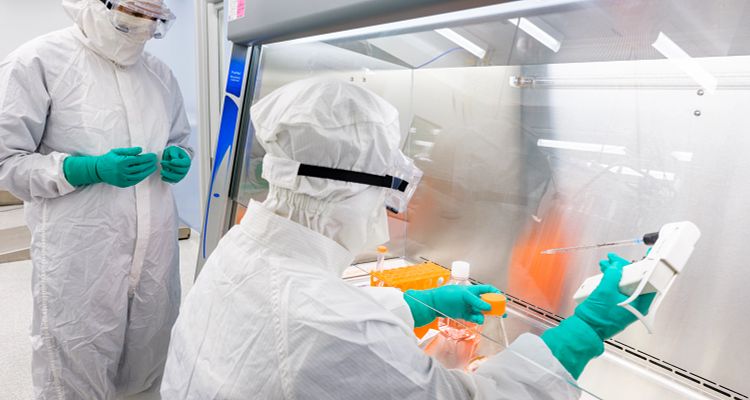 CDMO operators work within a Charles River GMP viral vector manufacturing suite