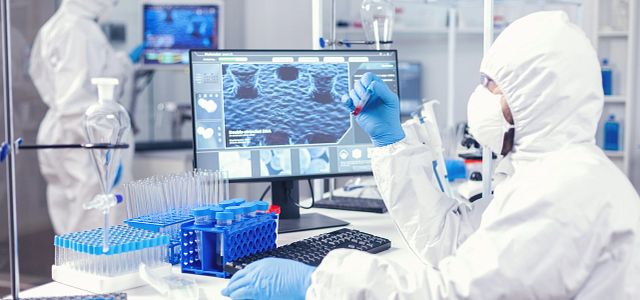 Doctor working with various bacteria and tissue researching the development of vaccine in a medicine lab