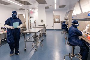 Charles River lab technicians wearing blue and white PPE working at our Memphis CDMO facility.