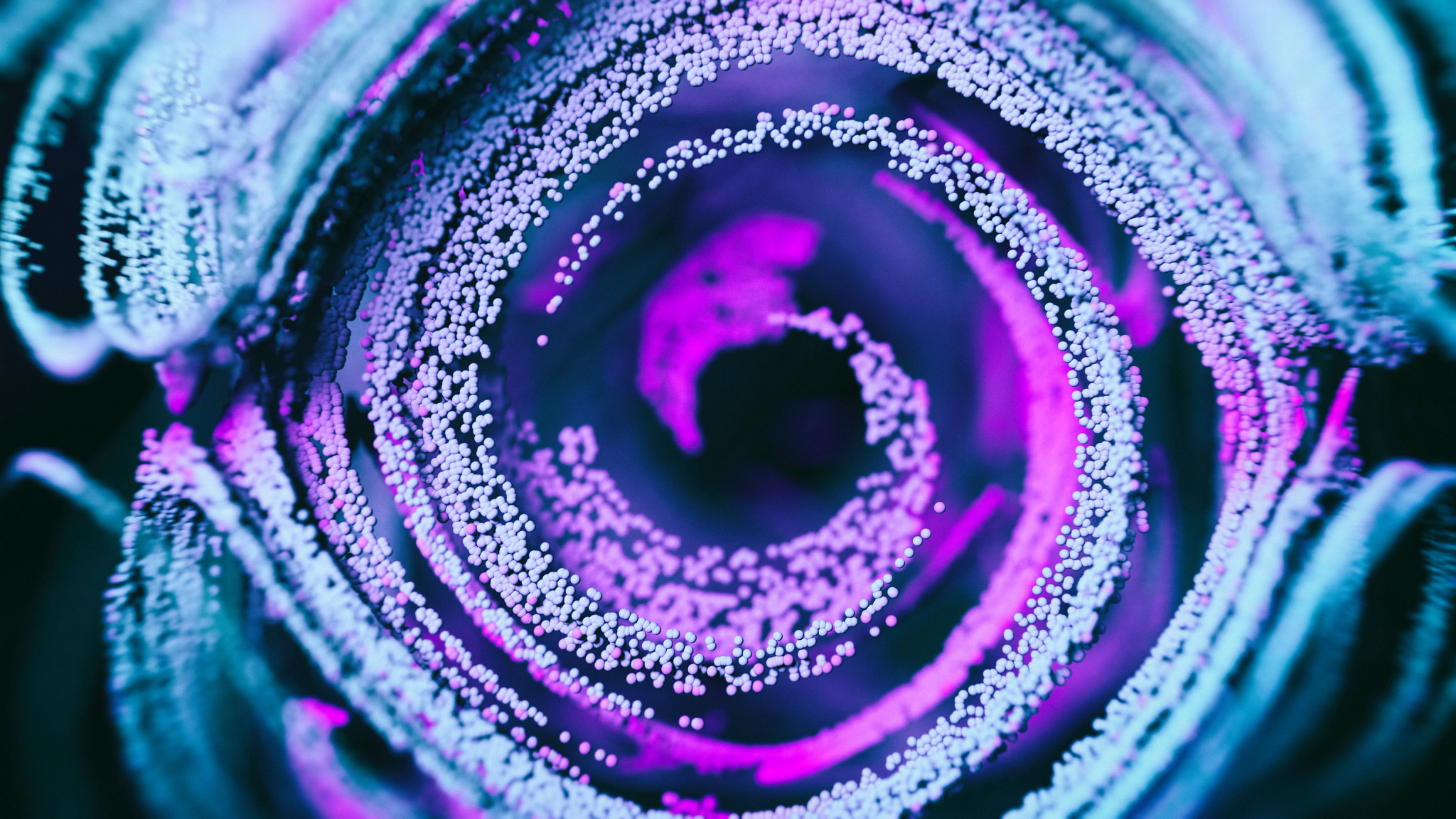 abstract particles in pink, white, blue swriling in a circle