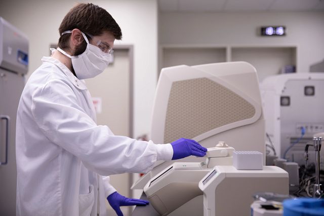 Technician running a biologics testing machine