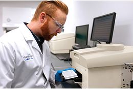 Lab technicians working to implement a rapid microbial method into their global processes