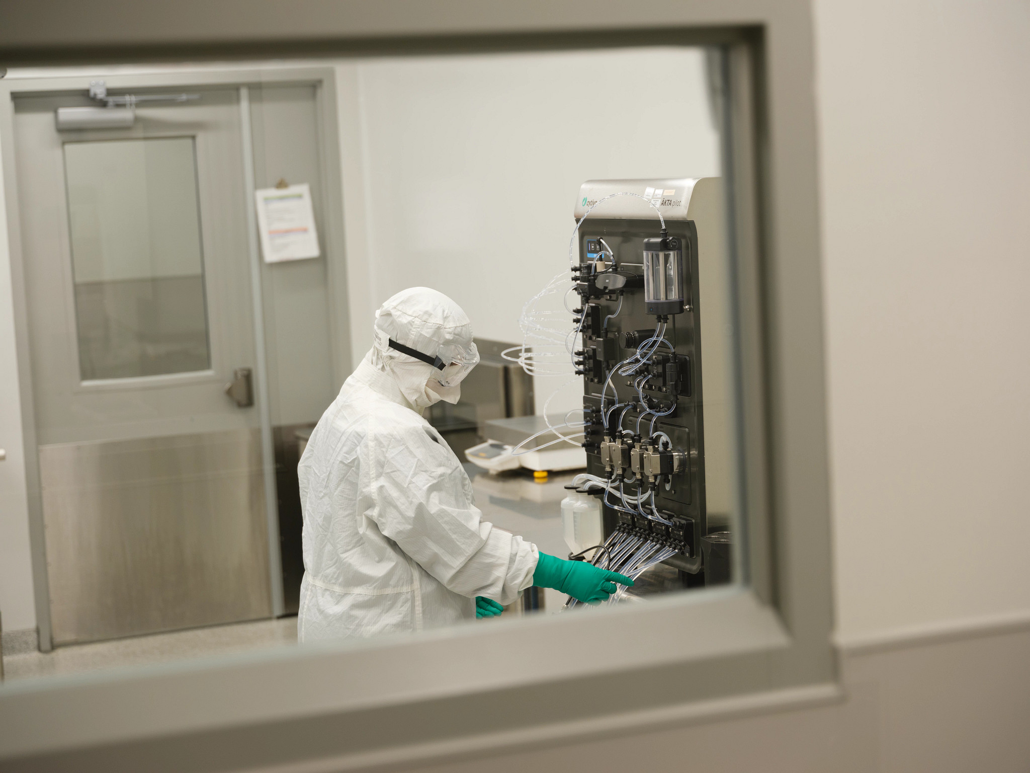 Scientist working in a lab wearing full PPE.