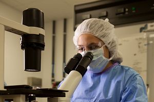 Charles River scientist looking through a microscope