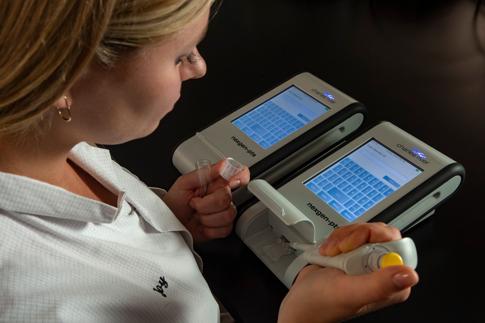 Technician performing assay for host cell proteins (HCPs) in a lab.
