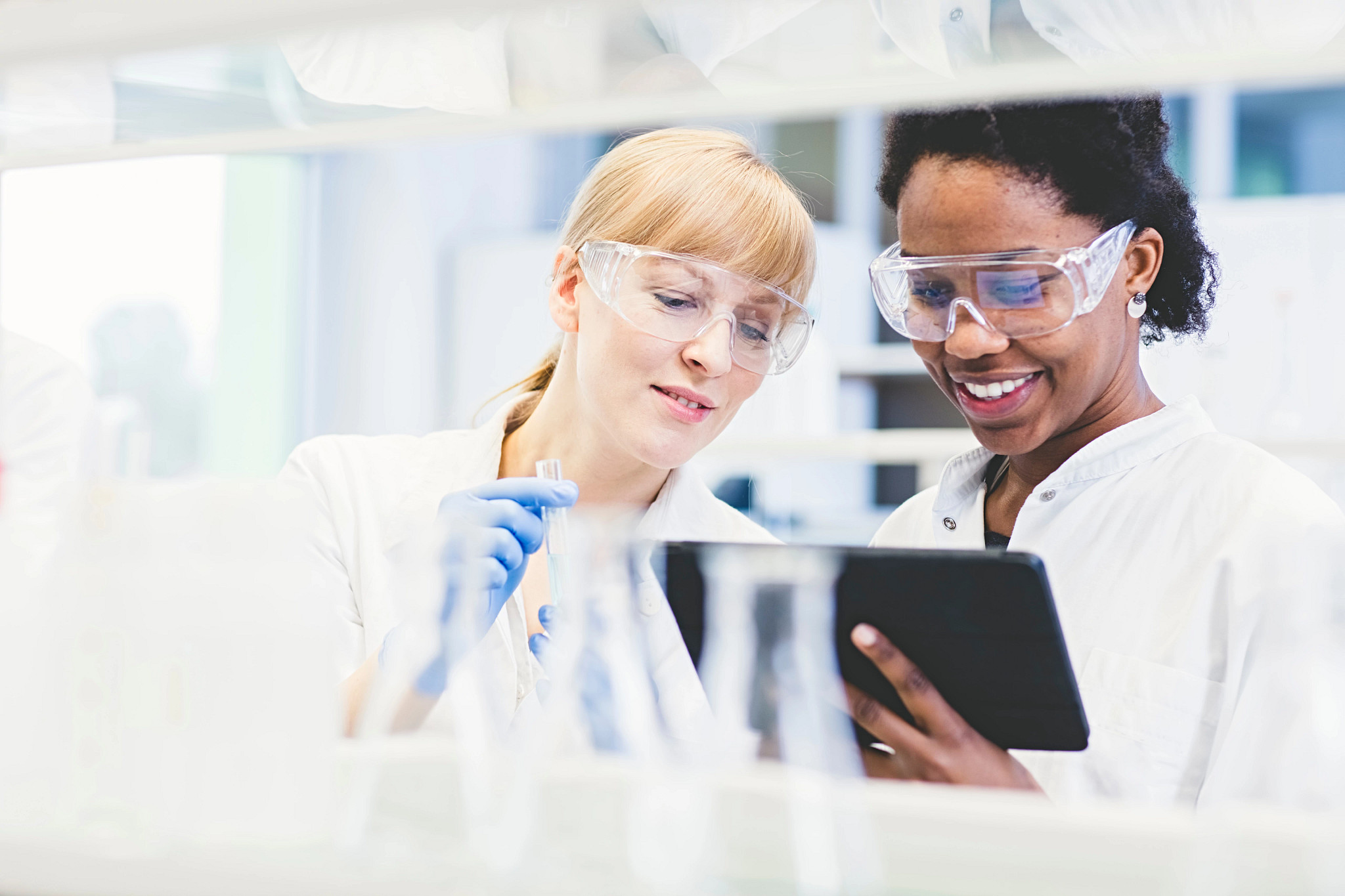 Lab Technicians Reading a Report on a Tablet