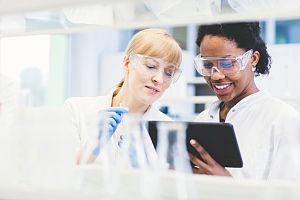 Lab Technicians Reading a Report on a Tablet