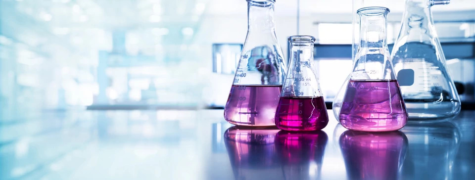 An image of conical flasks filled with liquid, representing Charles River’s scale-up chemistry and process chemistry services.