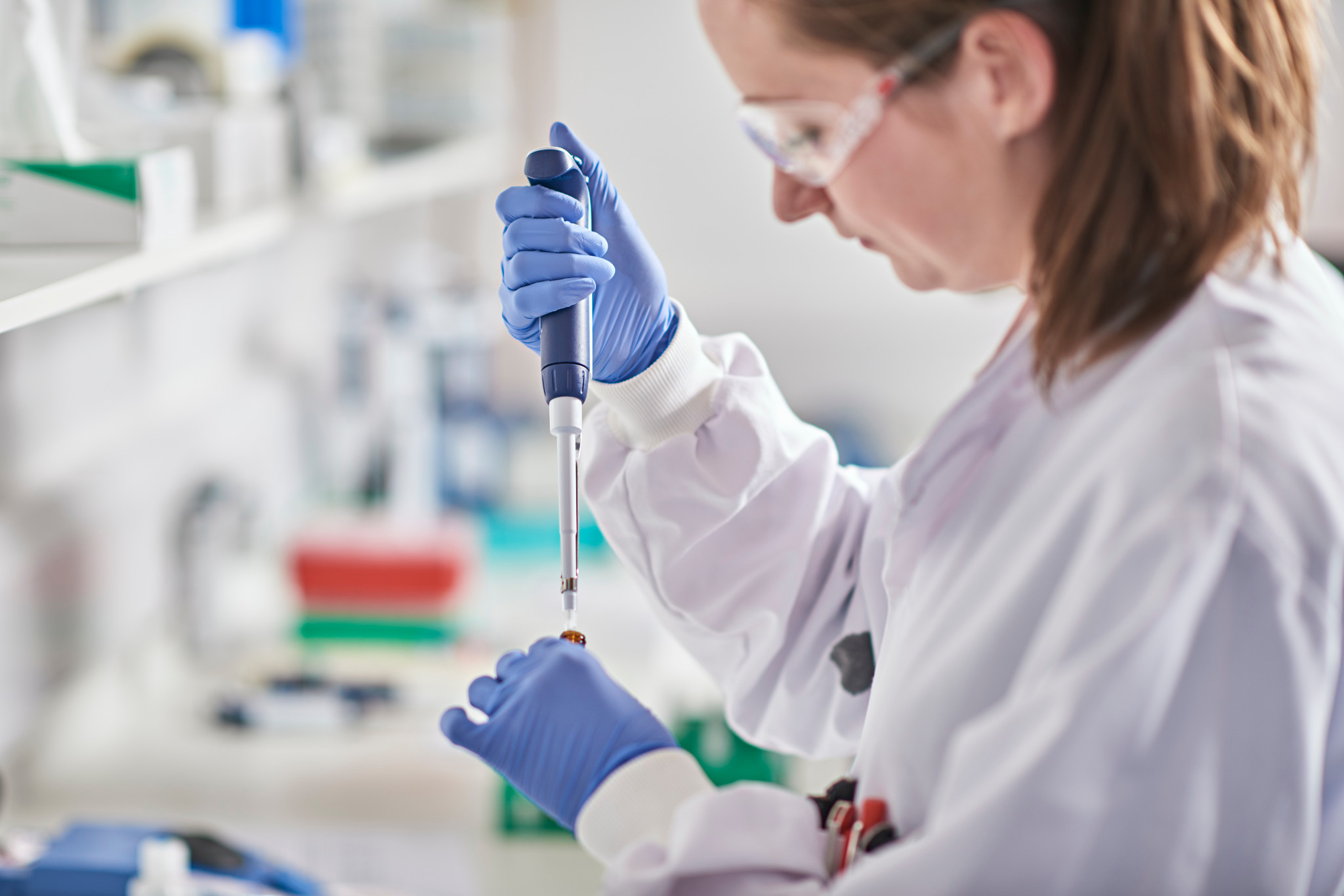 scientist in lab pipetting a volume-limited sample