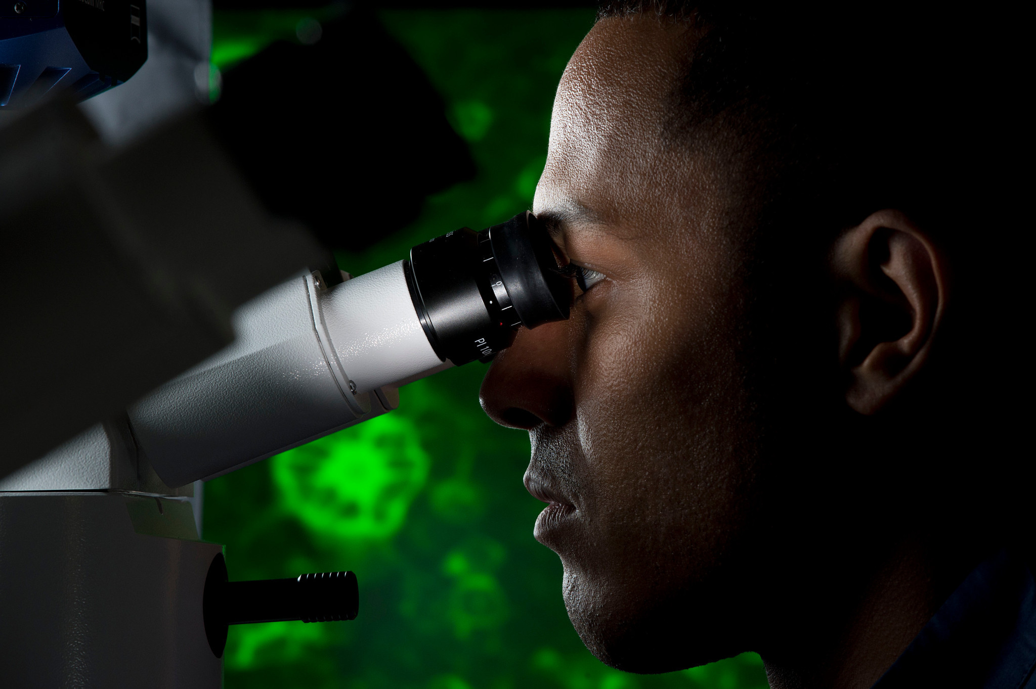 researcher using a microscope