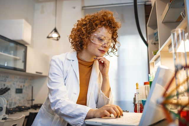 female scientist working on laptop