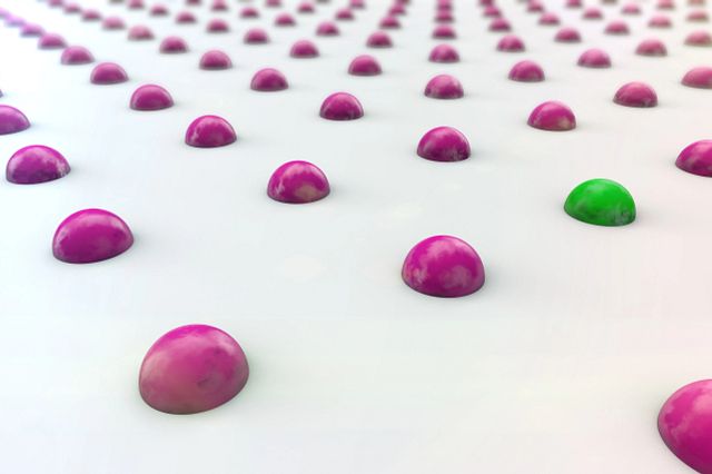 Graphic image of purple and green spots representing the data results from the Cell Microarray Array technology. 