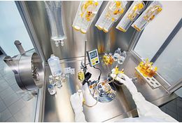 Quality control microbiologist working in biological safety cabinet for validation of microbiological methods