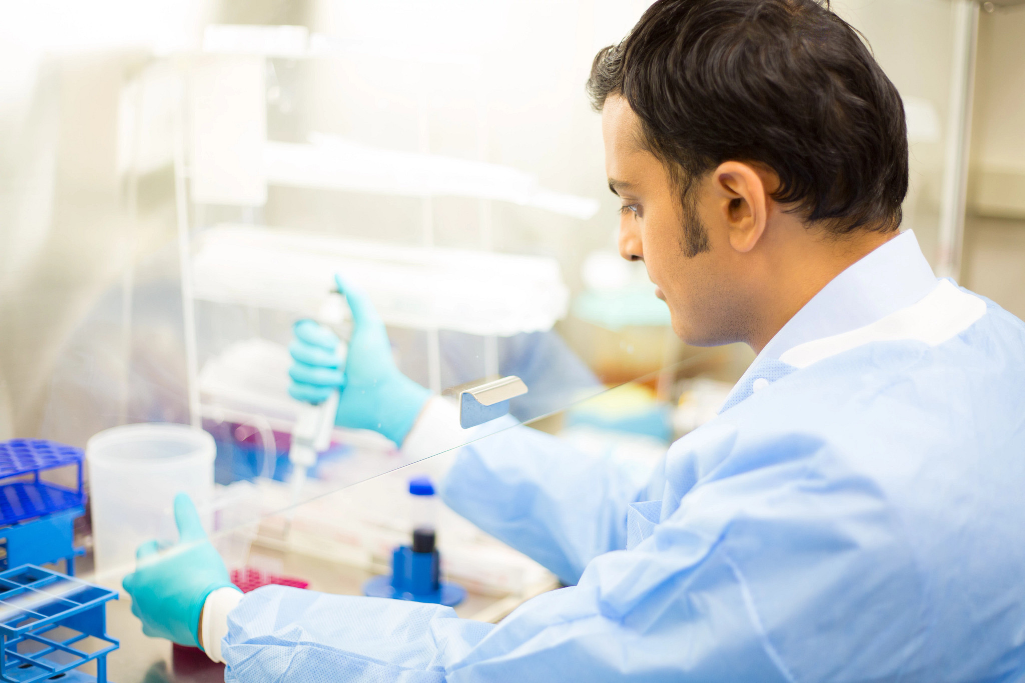 man in lab working under hood