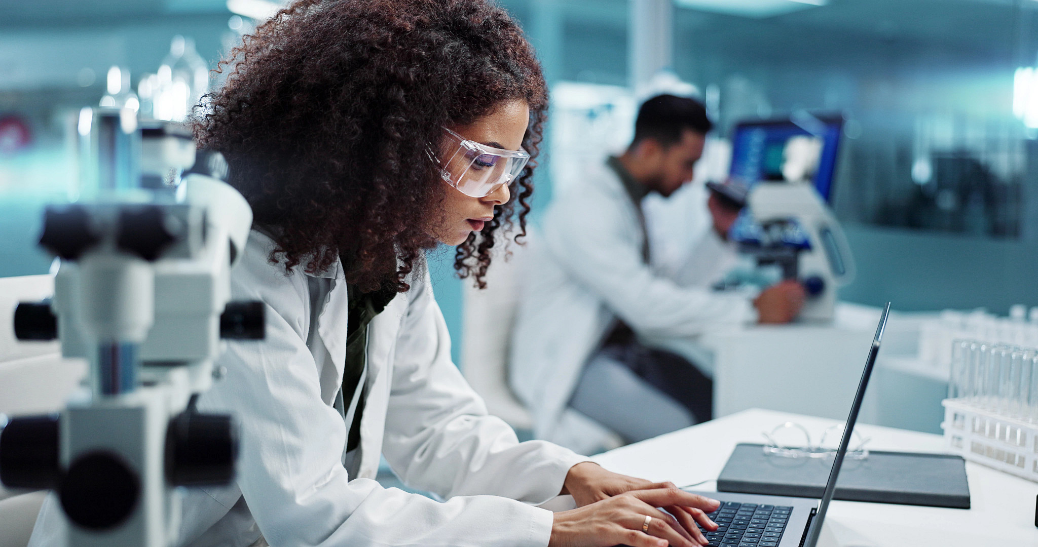 Charles River lab technician working on a laptop in a laboratory