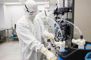 technician wearing full PPE at machine