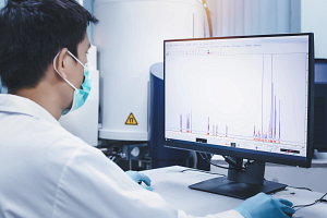 Scientist evaluating NMR data on a computer screen.