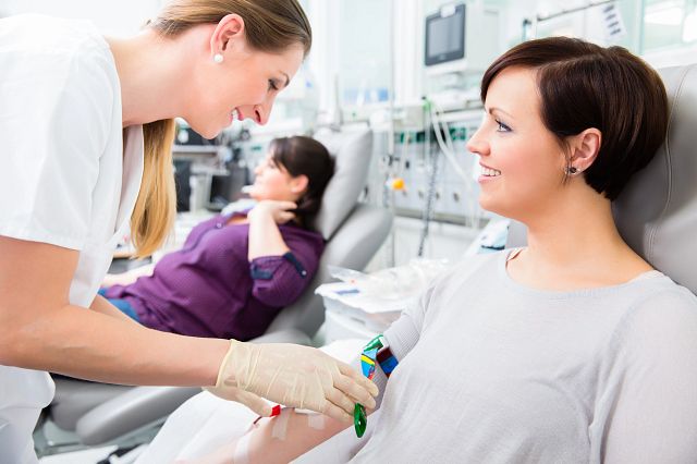 Nurse drawing blood from patient.