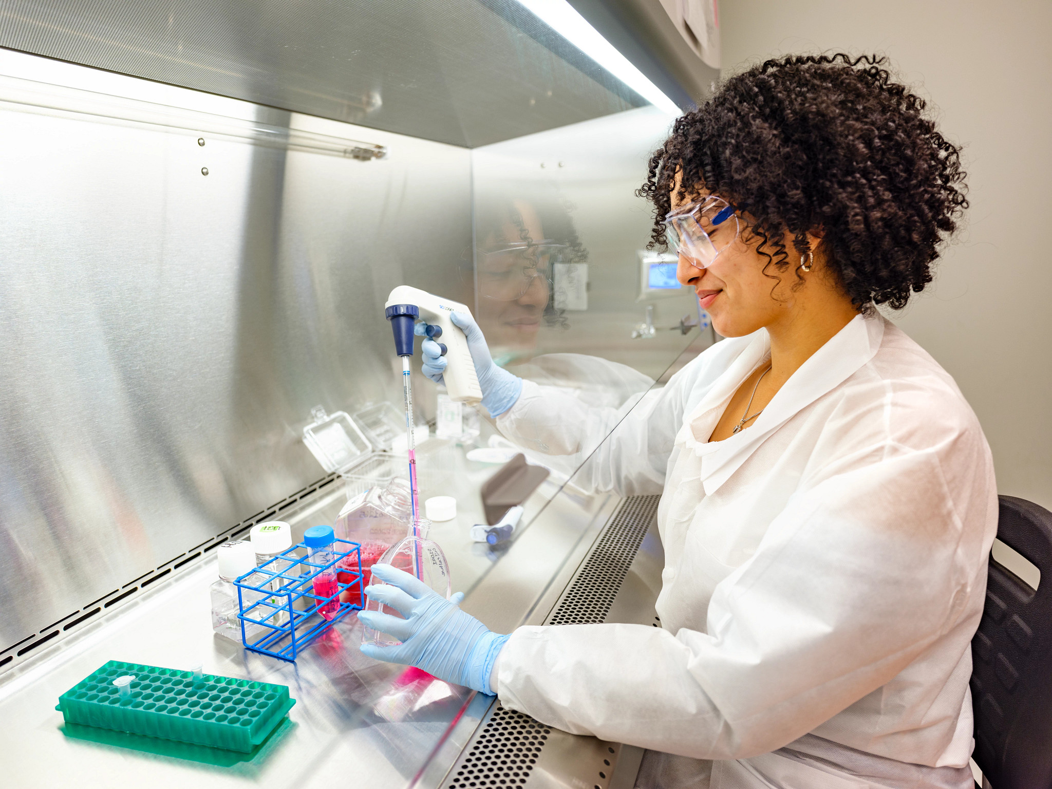 Scientist in laboratory working with AAV reference materials for gene therapy research.