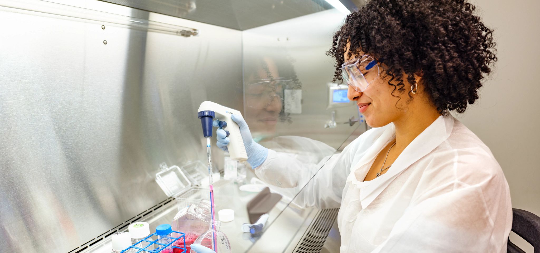 Scientist in laboratory working with AAV reference materials for gene therapy research.