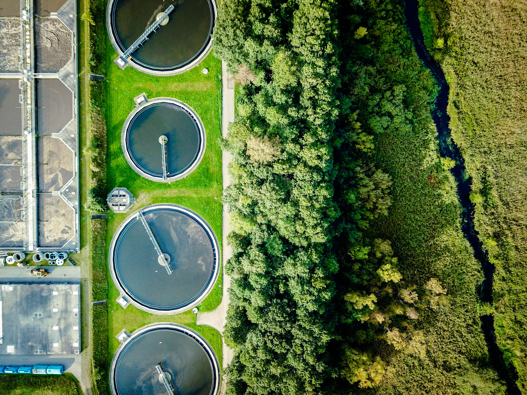 Aerial shot of sewage treatment plant placed near a river