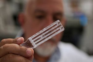 Scientist holds Endosafe cartridge in laboratory.