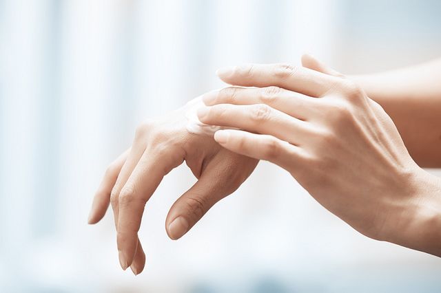 a person applying lotion to their hands