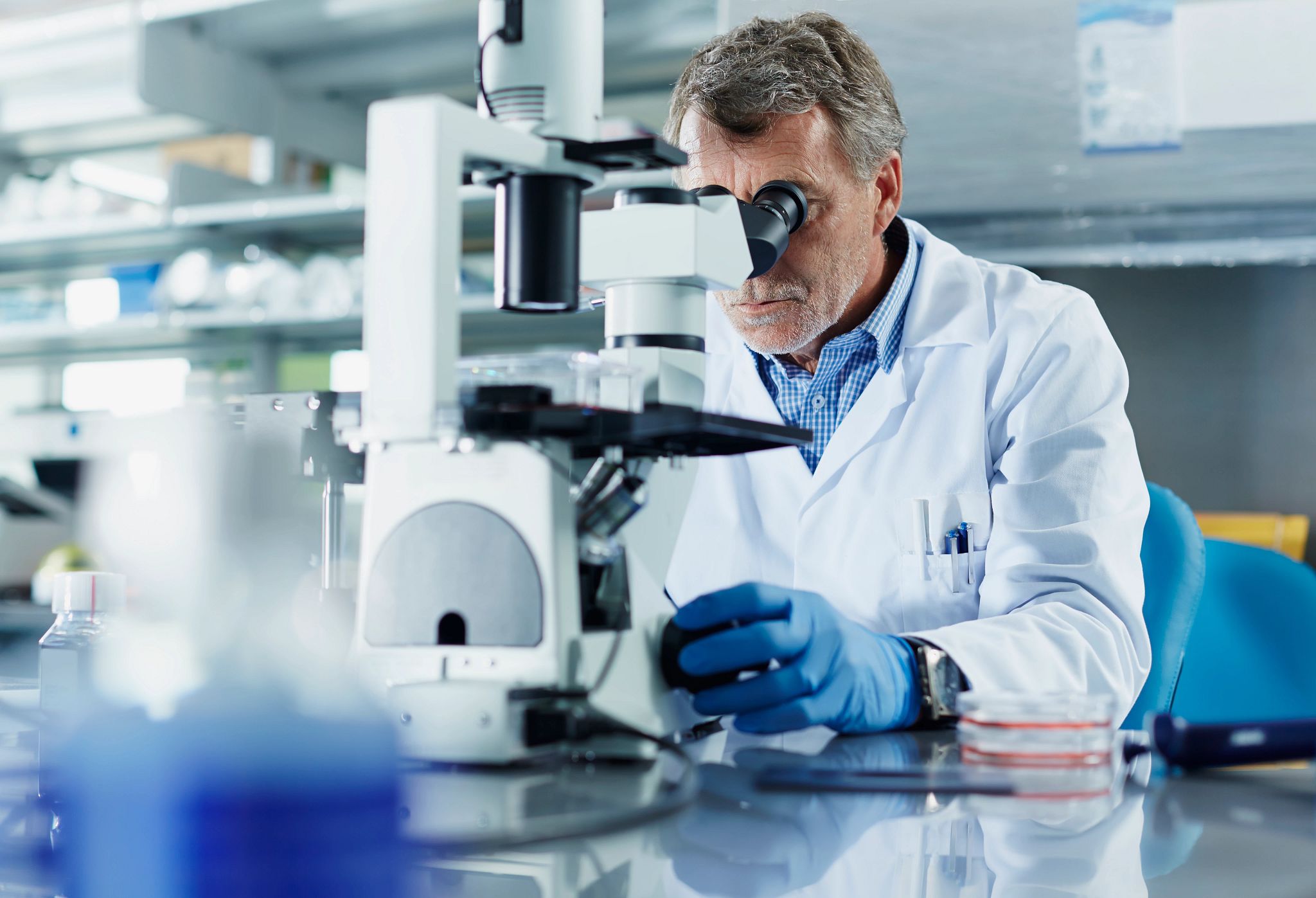 male technician engaged in biologics testing activities in a laboratory setting