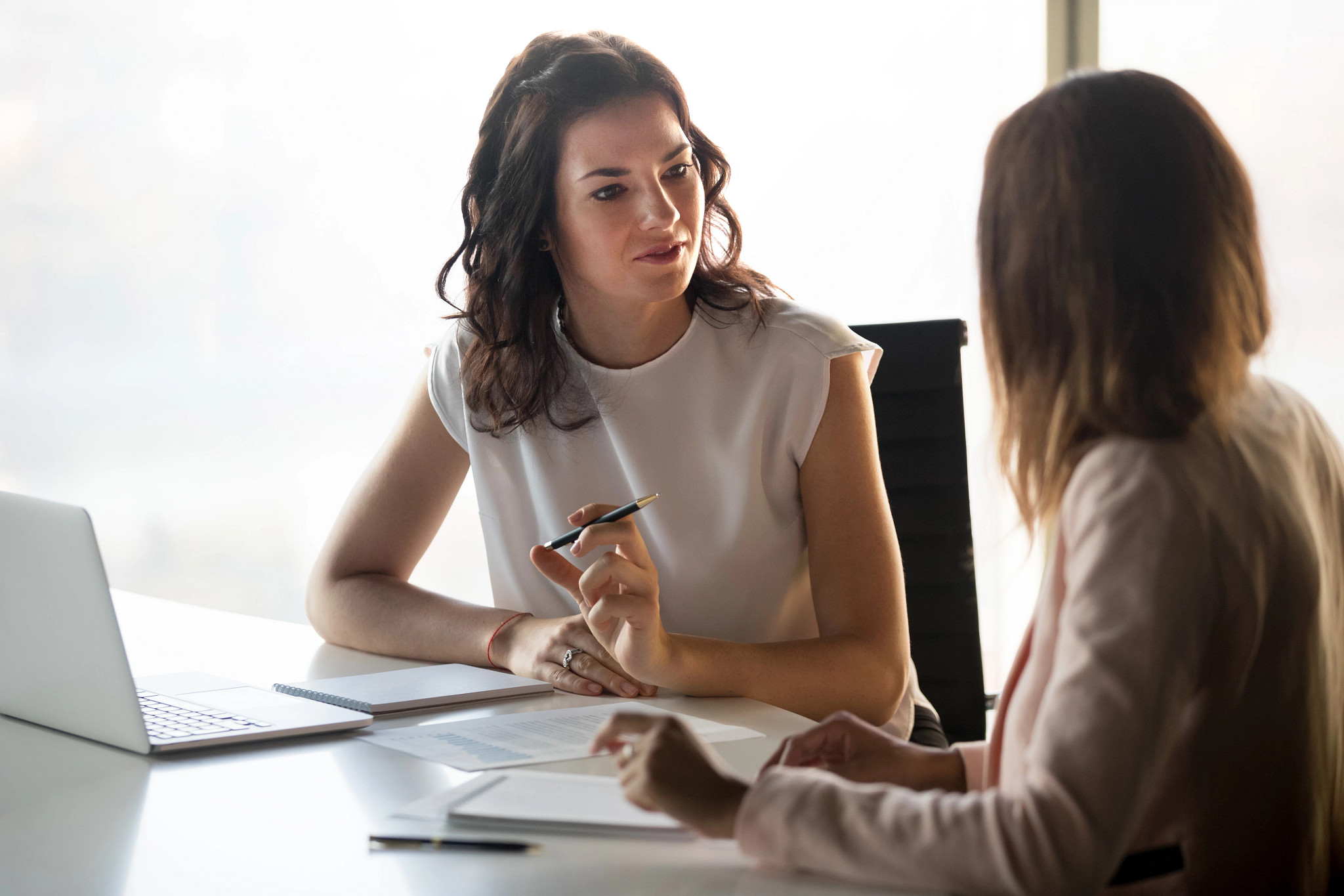 two women in business attire discussing vivarium operations consulting