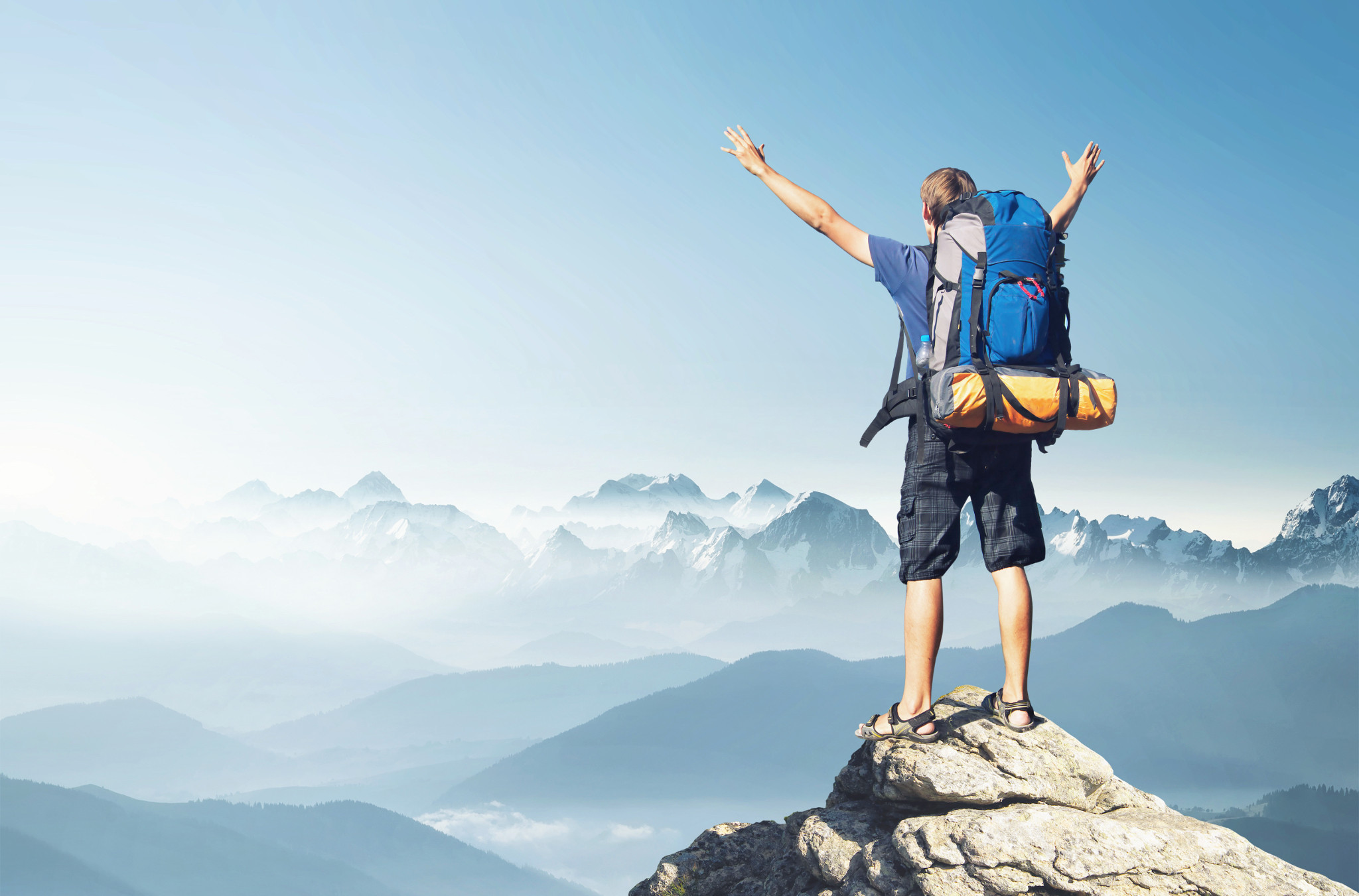 Hiker standing at the top of a mountain.