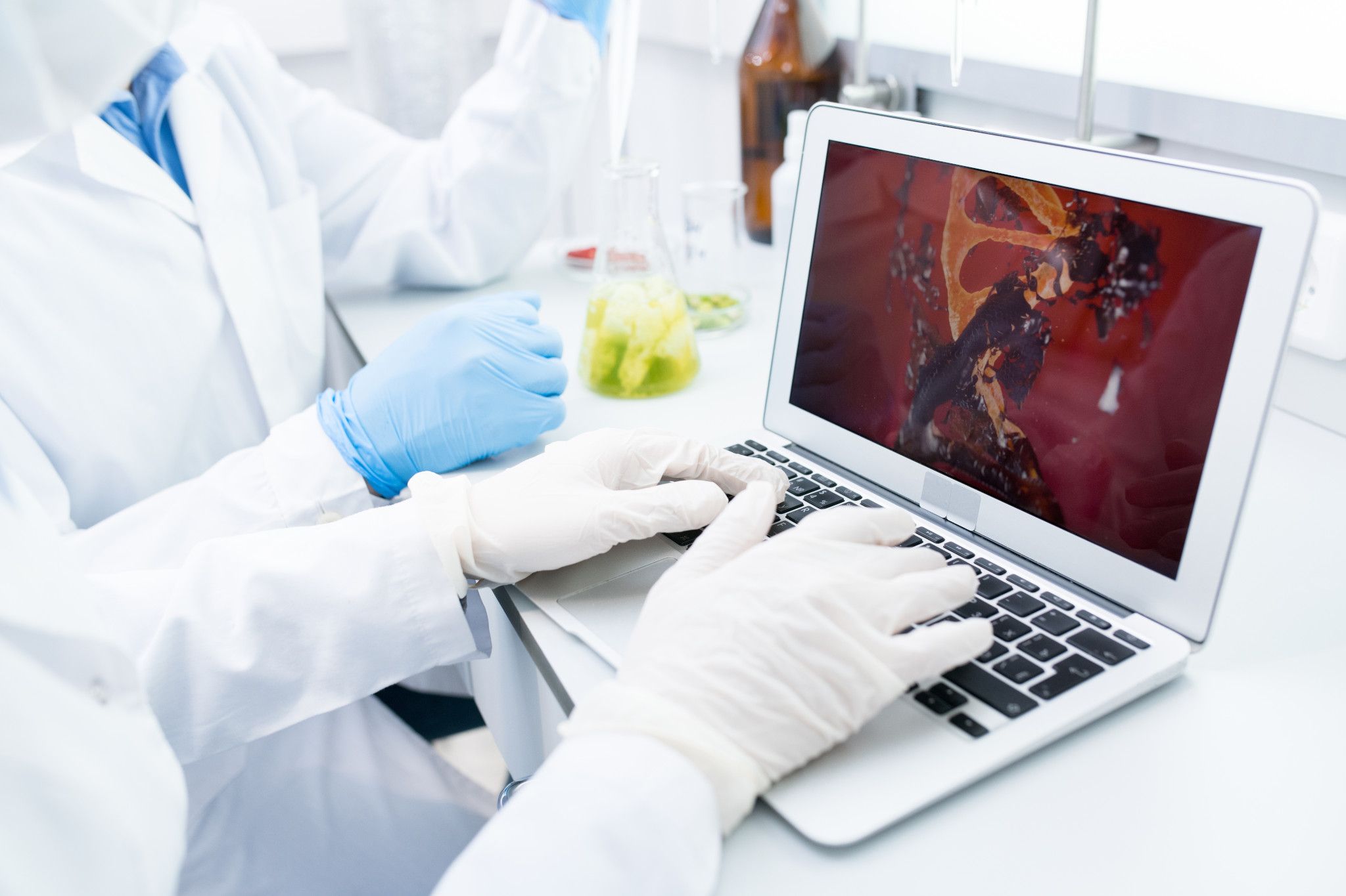 picture of scientist typing on laptop