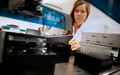 Lab technician using Charles River Nexus system.