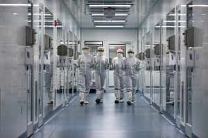 Scientists wearing full PPE walking down a hall at the Memphis facility.