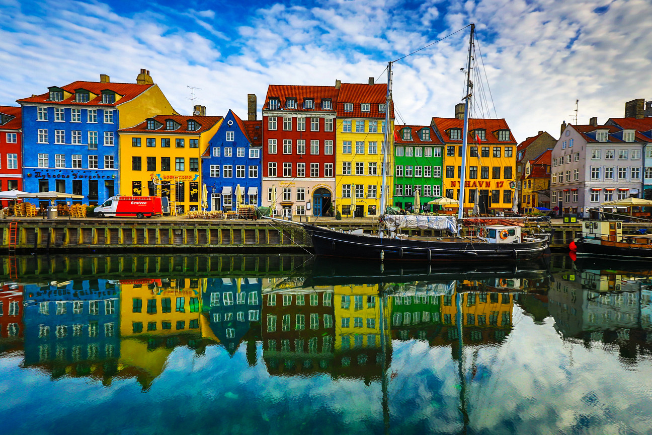 colorful row houses along a river in copenhagen