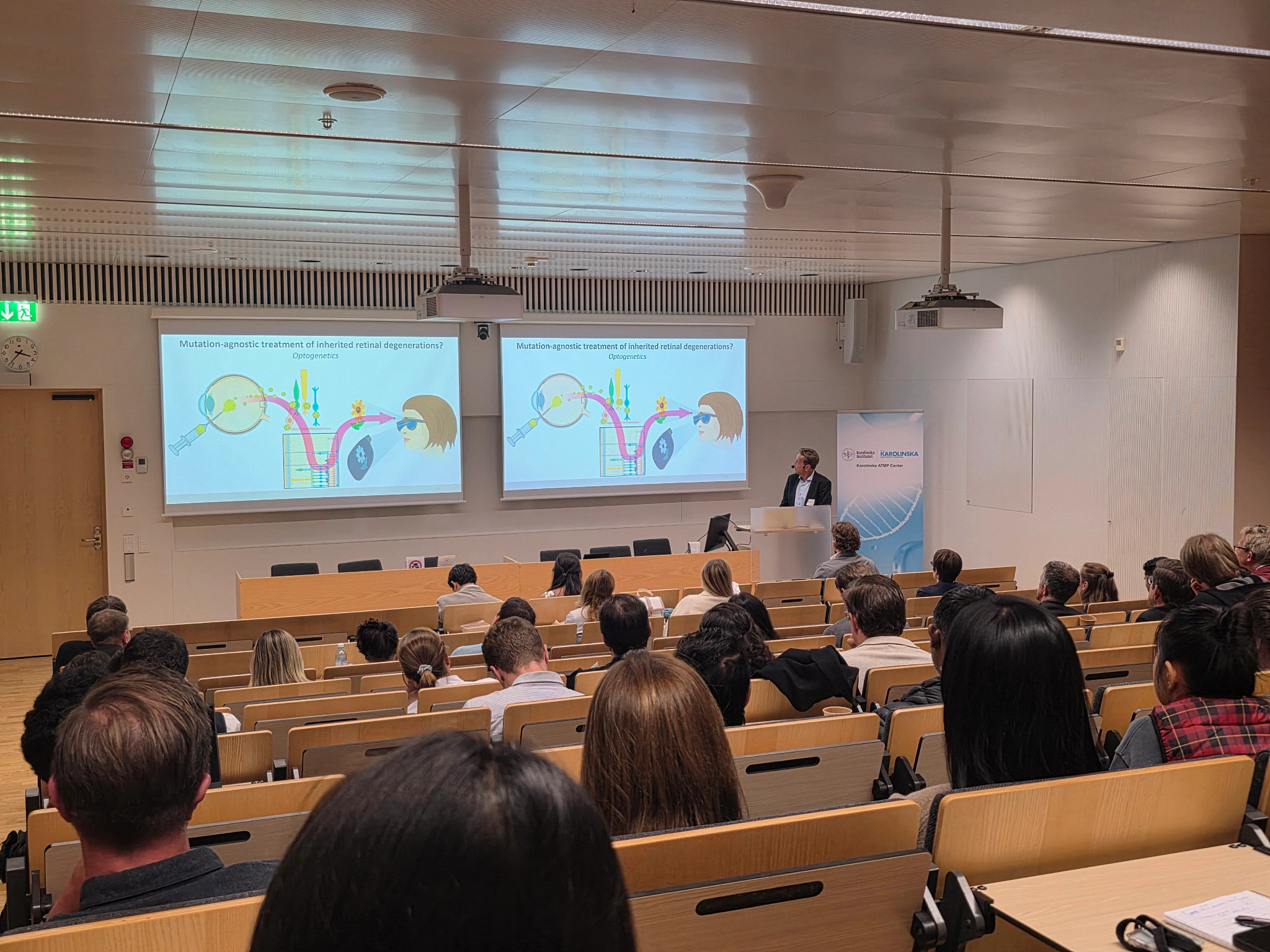 Photograph of a presentation in a lecture theatre setting, taken at the In Vivo Gene Therapy Symposium