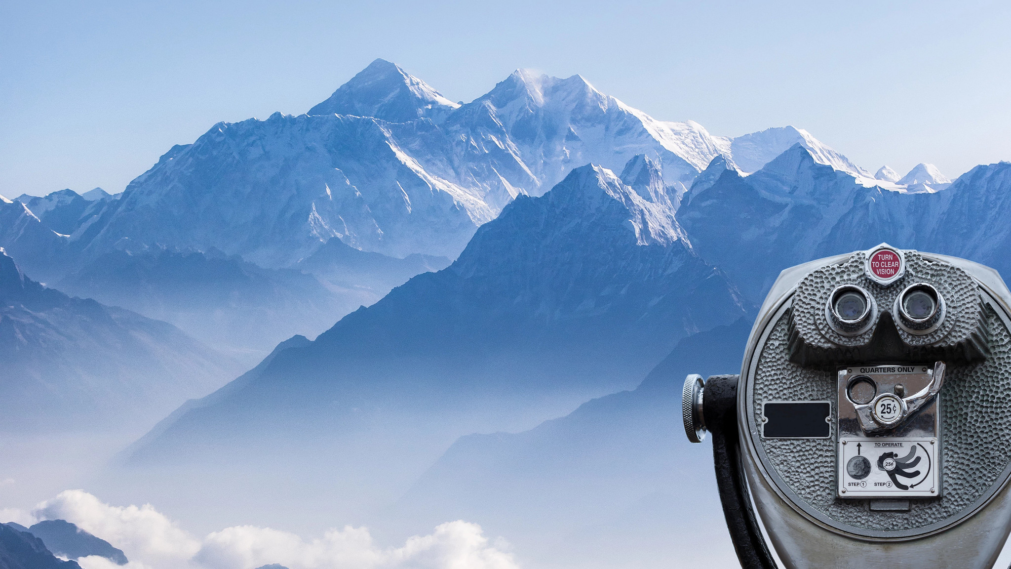 Daylight view of Mount Everest with binoculars in the foreground.