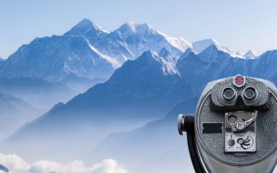 Daylight view of Mount Everest with binoculars in the foreground.